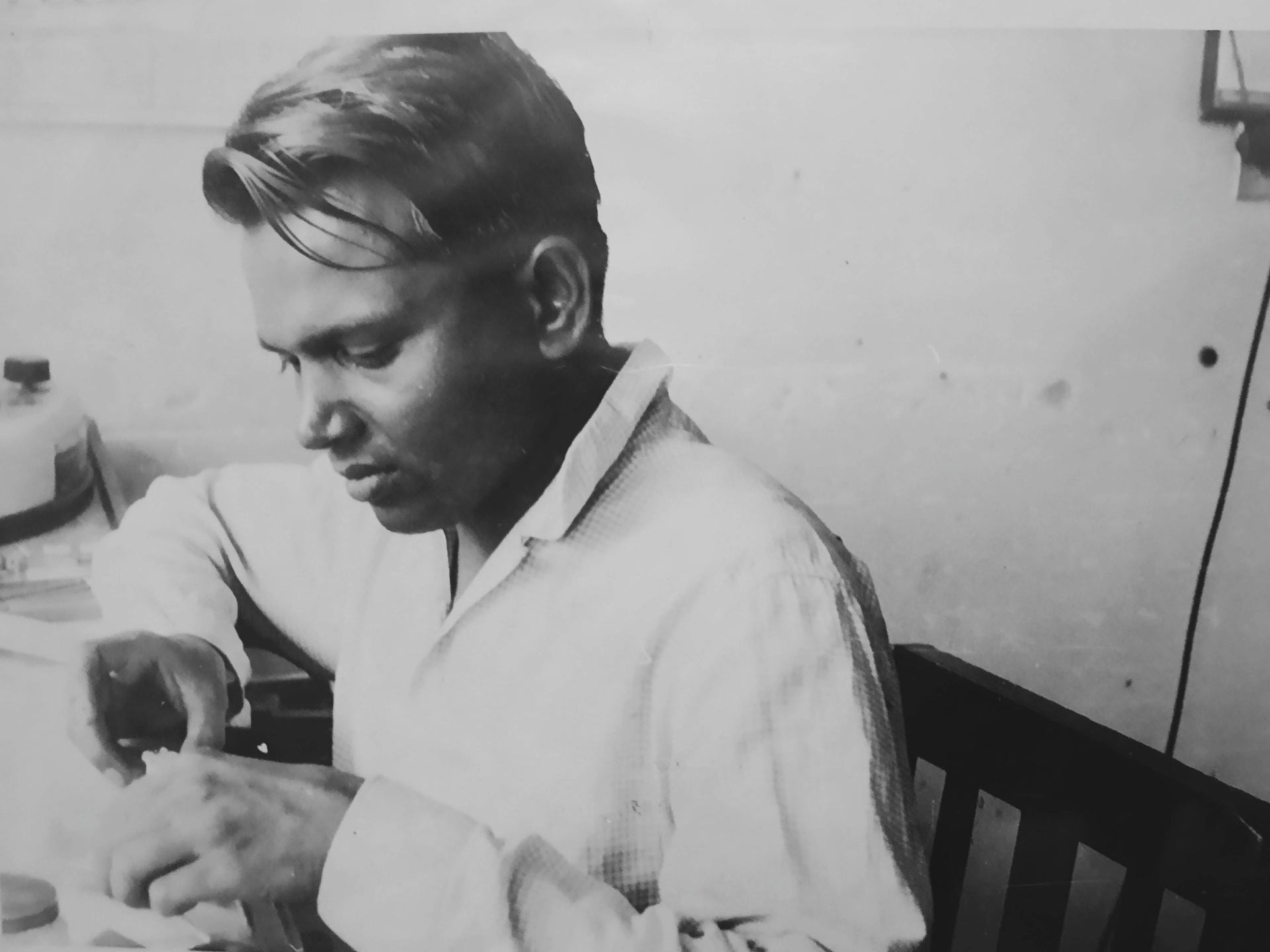 A photograph of Mo's grandfather while working on a watch. 